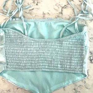 this is a light silver is blue corset, crop top from Pacsun.